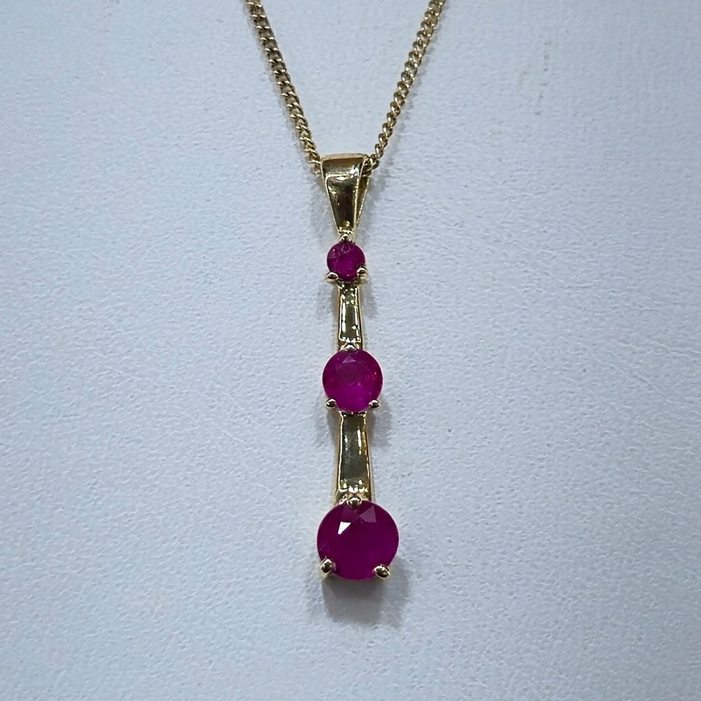 9ct Yellow Gold 3 Stone Ruby Drop Pendant on 18 inch chain