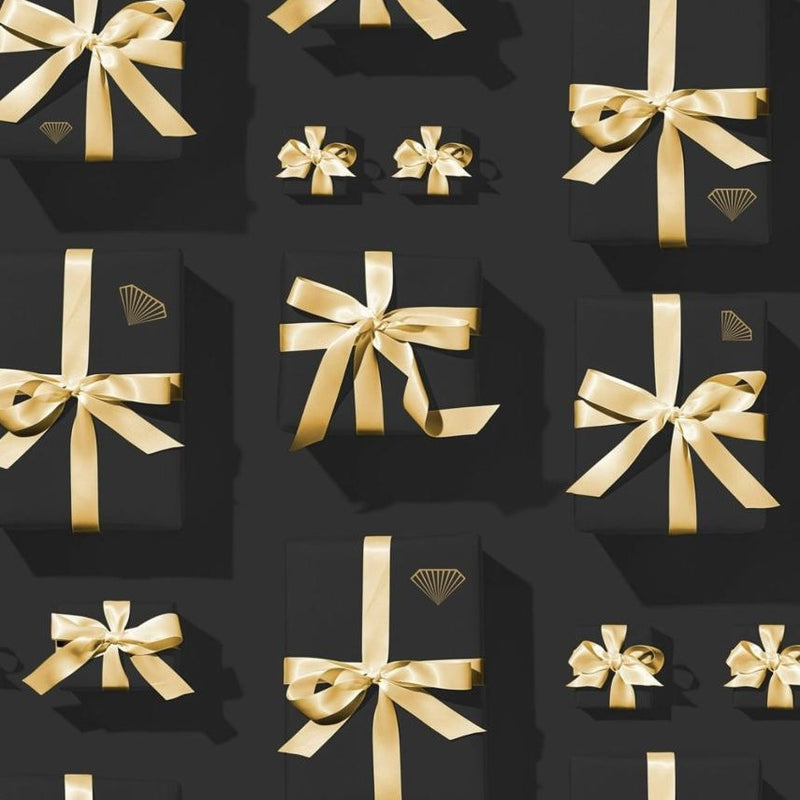 Black gift boxes with gold ribbons